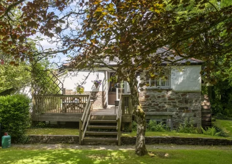 The decked terrace, alfresco dining area & rear lawned garden at The Watermill, Withiel