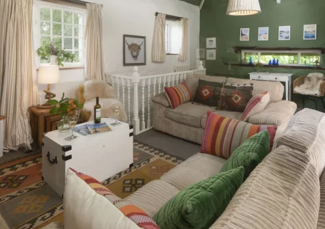 The Watermill, Withiel is a charming early 1800s cottage set within 65 private acres of woodland and farmland, featuring a working waterwheel, sun-soaked deck, cosy wood burner, tennis court and croquet lawn for a peaceful Cornish family escape.