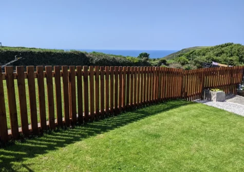 The enclosed garden & outdoor sitting area, with countryside views & glimpses of the ocean, at The West Wing, Morwenstow