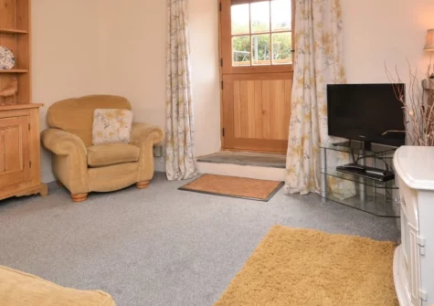 The West Wing, Morwenstow is a charming single-bedroom cottage set within an organic family farm near Cornwall's dramatic north coast, featuring original character, enclosed garden with ocean glimpses, and easy access to coastal paths and beaches.