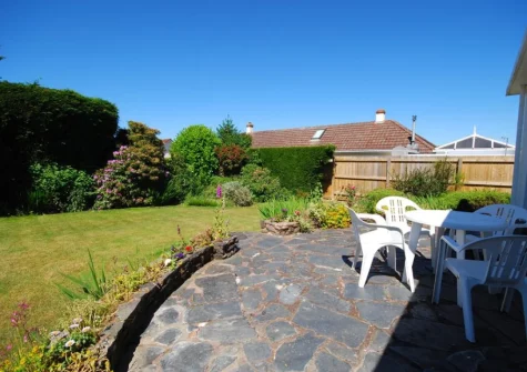 The patio, alfresco dining area & enclosed rear garden at The Willows, South Molton