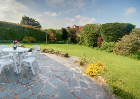 The patio, alfresco dining area & enclosed rear garden at The Willows, South Molton