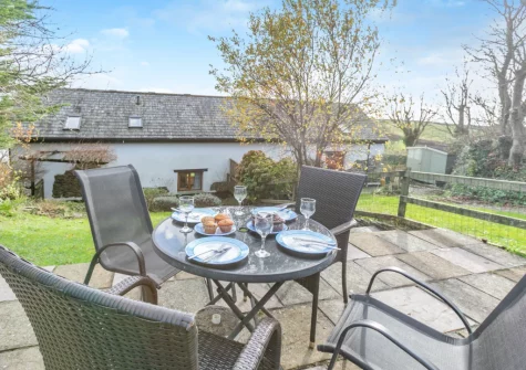 The patio & alfresco dining area at Thistledown Cottage, Poughill