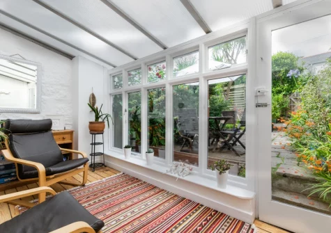 The sunny conservatory at Three Blind Mice, Mousehole