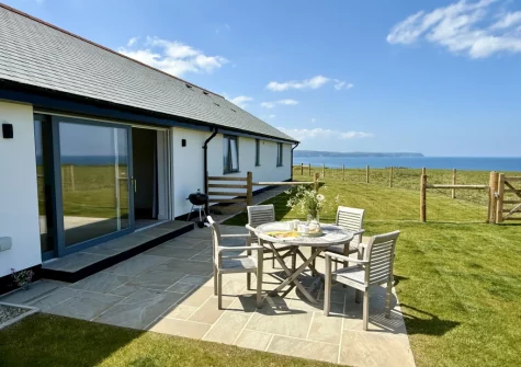 The patio, barbecue, alfresco dining area & enclosed garden at Three Corners Barn, Greencliff Farm, Abbotsham