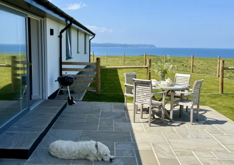 The patio, barbecue, alfresco dining area & enclosed garden at Three Corners Barn, Greencliff Farm, Abbotsham