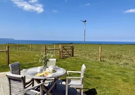 The patio, barbecue, alfresco dining area & enclosed garden at Three Corners Barn, Greencliff Farm, Abbotsham