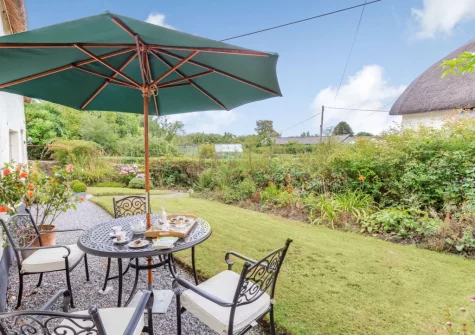 The alfresco dining area & garden at Three Hares Cottage, Throwleigh