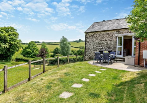 The patio, alfresco dining area & enclosed garden at Threshers Barn, East Anstey