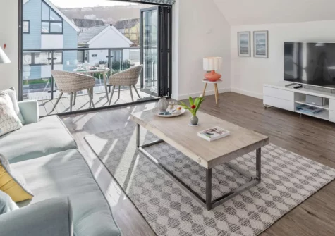 Tides 45, Westward Ho! is a stunning reverse-level retreat just moments from golden sands and famous surf, boasting contemporary open-plan living, three elegant bedrooms with garden access, and a balcony with glimpses towards the sea.
