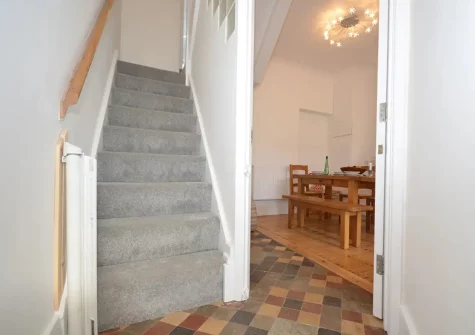 Stairs up to the first floor (bedroom #2 & #3 and bathroom) at Tolcarne Cottage, Newquay