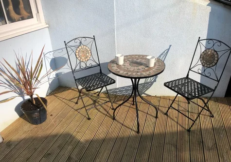 The decked courtyard & outdoor sitting area at Tolcarne Cottage, Newquay
