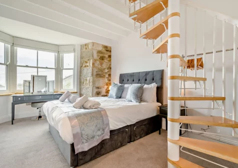 Bedroom #2, with spiral staircase that leads to a captivating lookout room, at Torre Vean Manor, Porthleven