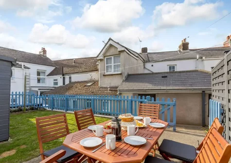 The rear patio, alfresco dining area & garden at Torridge House, Instow