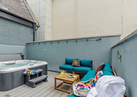 The decked patio, outdoor sitting area & hot tub at Towan House, Newquay