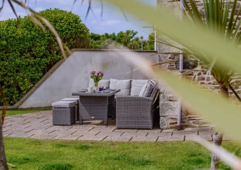 The patio, barbecue & alfresco dining area at Traeth Barn, Mawgan Porth