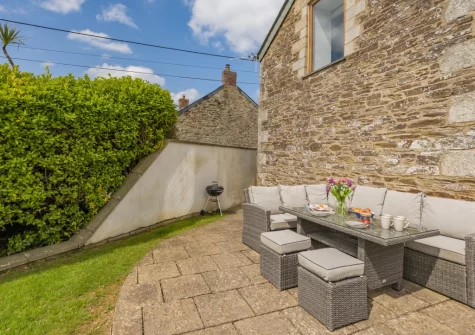 The patio, barbecue & alfresco dining area at Traeth Barn, Mawgan Porth