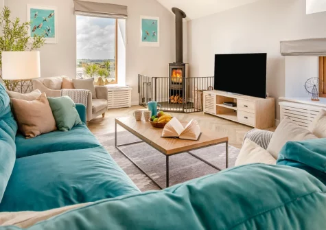 Traeth Barn, Mawgan Porth is a handsome three-bedroom stone barn in peaceful Trenance, boasting countryside and sea views, stylish reverse-level living spaces, shared paddock access for dogs, and a private path to golden Mawgan Porth Beach.