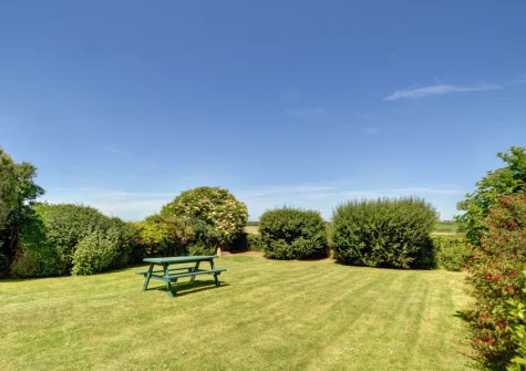 The enclosed rear lawned garden & alfresco dining area at Trearth, St Merryn