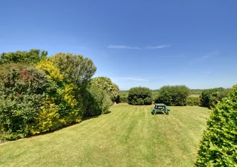 The enclosed rear lawned garden & alfresco dining area at Trearth, St Merryn