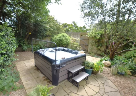 The hot tub & enclosed patio garden at Tredinnick Farmhouse, Gummows Shop