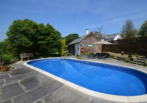 The outdoor heated swimming pool at Tredown Coach House, Broadwoodwidger
