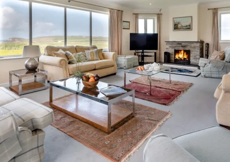 Trefebus, Constantine Bay is a spectacular six-bedroom house beside Trevose Golf Course, featuring panoramic ocean views from a sun-drenched balcony, contemporary interiors, and Constantine Bay's golden sands just 400 metres away.