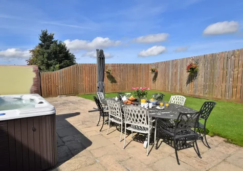 The patio, alfresco dining area, hot tub & garden at Trelow Barton, Tredinnick
