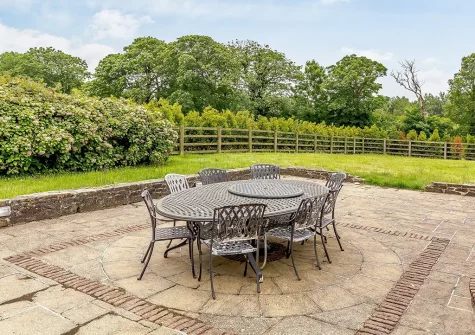 The patio, alfresco dining area & garden at Trelow Farmhouse, Tredinnick