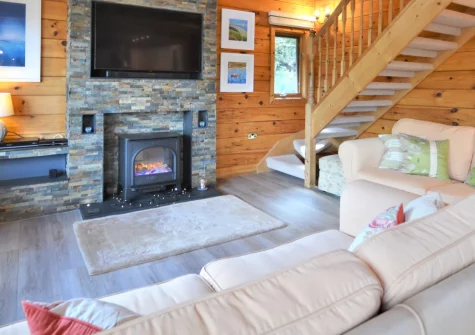 Trelowen, Little Petherick is an atmospheric Canadian-style log cabin in Little Petherick village near Padstow, featuring striking timber interiors, a mezzanine snug with balcony, three-tiered garden terracing, and walks to Little Petherick Creek.