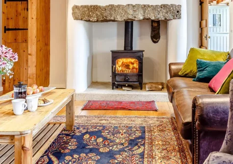 Trenethick Barns, Mount Hawke is a luxurious five-bedroom barn conversion blending rustic charm and modern comfort. With wood burners, a games room and garden, it offers easy access to coastal paths & charming villages for perfect family holidays.