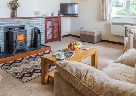 Trengilly Vean, Constantine is a charming single-storey cottage on a working farm with spectacular countryside views. Featuring cosy interiors & enclosed garden, it welcomes four guests and up to five dogs for an authentic rural Cornish experience.