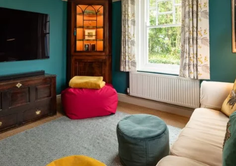 Trerair, Rock is a spacious dog-friendly house sleeping up to eight guests, with two cosy sitting rooms, a wood-burning stove, sunny walled garden with pizza oven and firepit, and an easy stroll to Porthilly beach and St Enodoc Golf Course.
