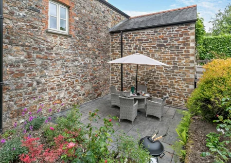 The secluded paved terrace, barbecue & alfresco dining area at Treverran Stables, Fowey