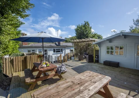 The decked patio, alfresco dining, sitting area & summer house at Trevethen Cottage, Crantock