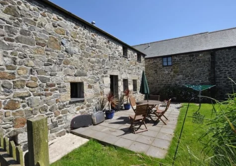 The patio, alfresco dining area & enclosed garden at Trewillis Farm Rose Barn, Coverack