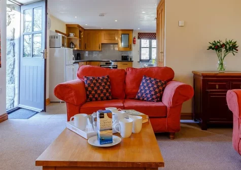 Trewillis Farm Rose Barn is a wonderfully serene stone cottage on a 150-acre working farm, offering authentic countryside charm. Explore Lizard Peninsula beaches and attractions whilst enjoying peaceful rural living and delightful farmyard memories.