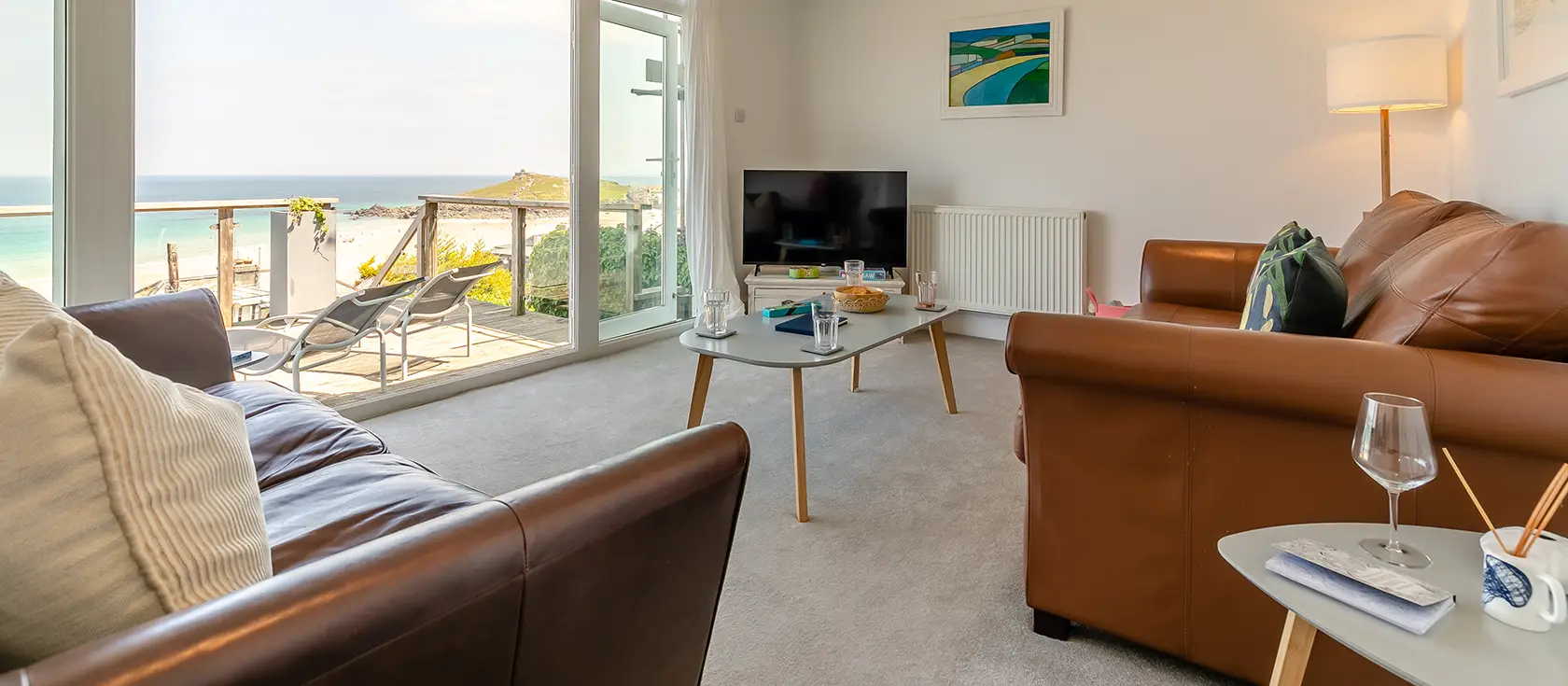 Trewirgie, St Ives is a stunning coastal haven with panoramic sea views, just steps from Porthmeor Beach. Featuring two stylish bedrooms qnd two-tiered decking, it's perfectly positioned for exploring Cornwall's artistic hub and rugged coastline.