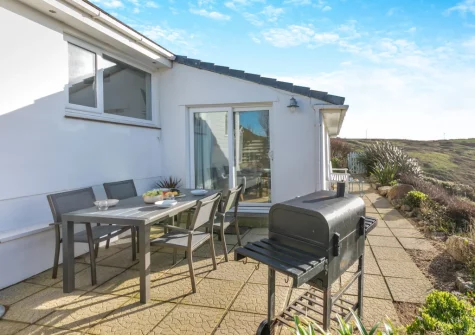 The patio, barbecue & alfresco dining area at Trewollas Beach Cottage, Sennen
