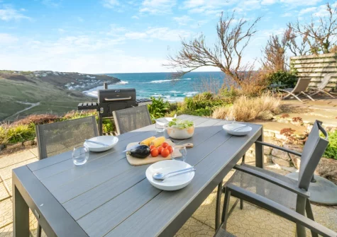 The patio, barbecue, alfresco dining area & terraced garden at Trewollas Beach Cottage, Sennen
