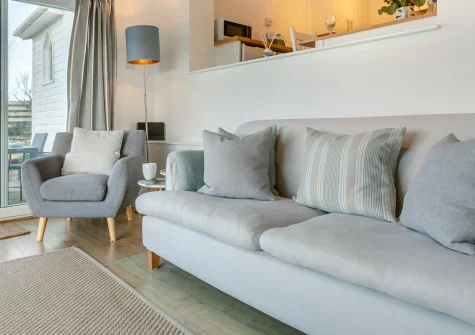Trewollas Beach Cottage, Sennen is a stylish two-bedroom cottage perched above Whitesands Bay, boasting spectacular uninterrupted sea views, a sun-drenched terrace with barbecue, and a private path leading directly down to the surfing beach below.