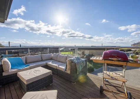 The decked balcony, barbecue & outdoor sitting area at Triskel, Morcliff, St Agnes