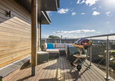 The decked balcony, barbecue & outdoor sitting area at Triskel, Morcliff, St Agnes