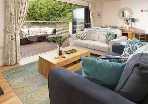 Triskel, Goonvrea is a charming two-bedroom lodge with spectacular ocean views towards St Ives. Enjoy contemporary comfort, wood-burning stove, private deck with barbecue, and coastal walks from this peaceful eco-friendly Cornwall retreat.