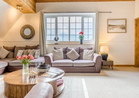 Tumbles Lodge, Hersham is an exceptional six-bedroom home near Bude, featuring a heated indoor pool and sauna, expansive gardens with play area, and generous living spaces, making it perfect for memorable family gatherings on Cornwall's coast.