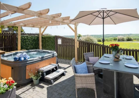 The patio, alfresco dining area & hot tub at Twinkle Cottage, Westward Ho!