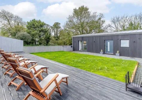 The decked terrace, outdoor sitting area & garden at Two Bees Barn, Bridgerule