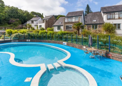 The shared outdoor swimming pool at The Valley, Carnon Downs