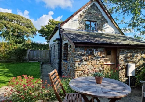 The patio, alfresco dining area & enclosed garden at Vines Cottage, Edistone