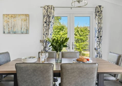 The dining area at Violet Lodge, 11 Roadford Lake Lodges, Broadwoodwidger